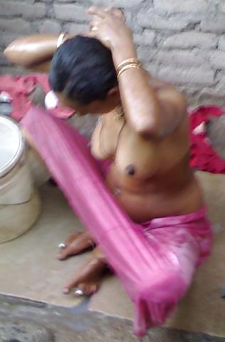 Village woman bathing in pink petticoat